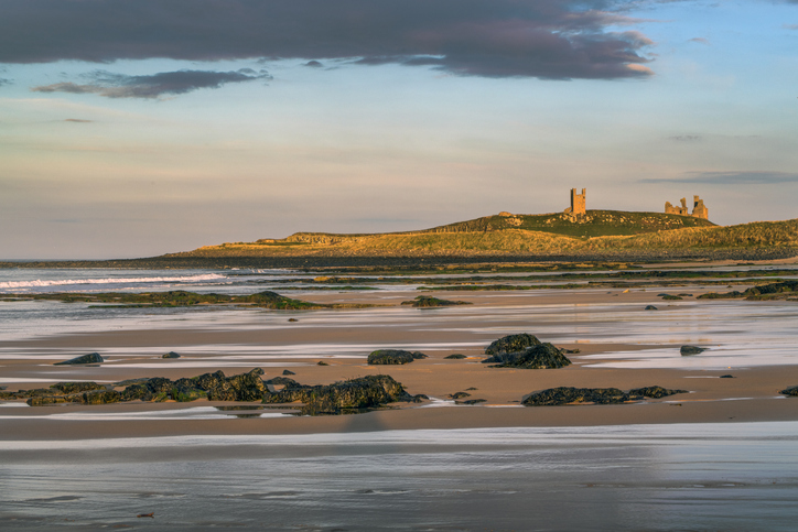 Sunsetting over Dunstanburgh castle on Embleton beach in Northumberland