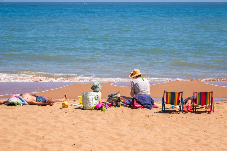 Family enjoying sunshine on the sandy beach at Stone Bay in the British seaside town of Broadstairs