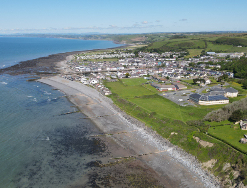 A breathtaking view of the mountainous landscape in Aberaeron North Wales, showcasing rugged terrain, winding trails, and serene lakes nestled between the hills. This picturesque setting is ideal for an unforgettable experience cycling in North Wales. 