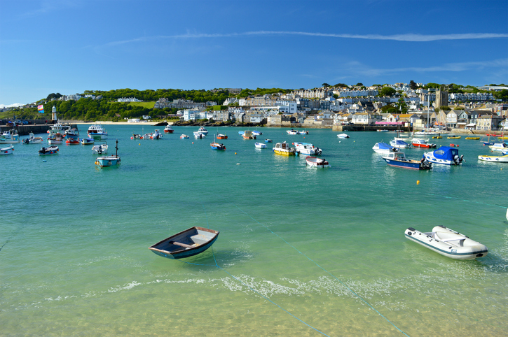 Looking towards the boats in St Ives harbour Cornwall on a perfect summer day on holiday in the UK.