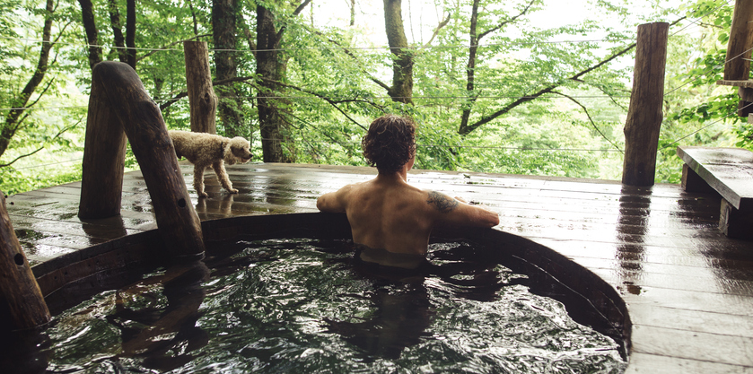 relaxed young holidaymaker is taking pleasure in bathing and wonderful scenery. back view photo.rest from work and household chores