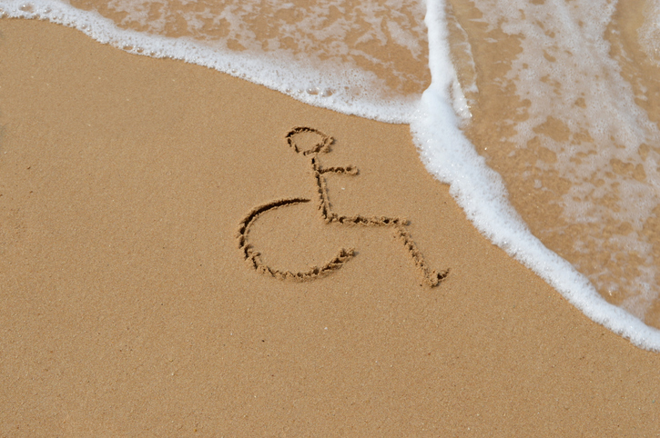 Symbol for disabled is drawn in the sand at the beach