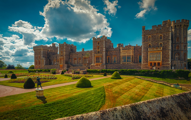 An ultra wide view of the medieval Windsor Castle and gardens bathed in glorious sunny weather