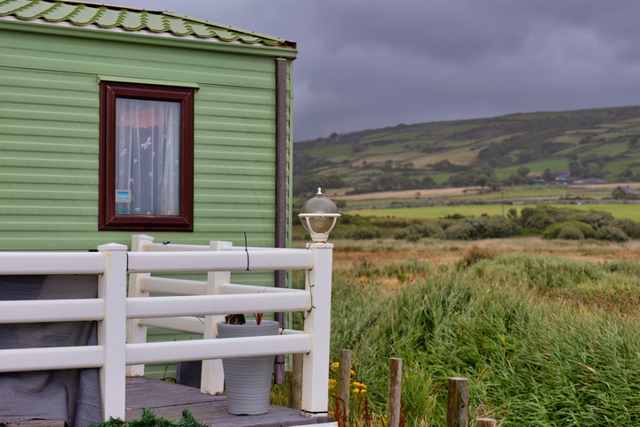 A fragment of a caravan and a view of the mountains and fields in Tal-y-bont, great Britain