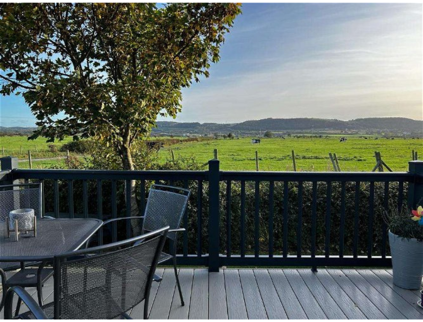 Image of the view from a static caravan deck in Ty Mawr Holiday Park in Wales, UK. 