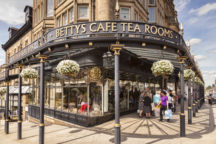 Harrogate, North Yorkshire, UK - Bettys Cafe Tea Rooms, and a queue waiting outside to go in.