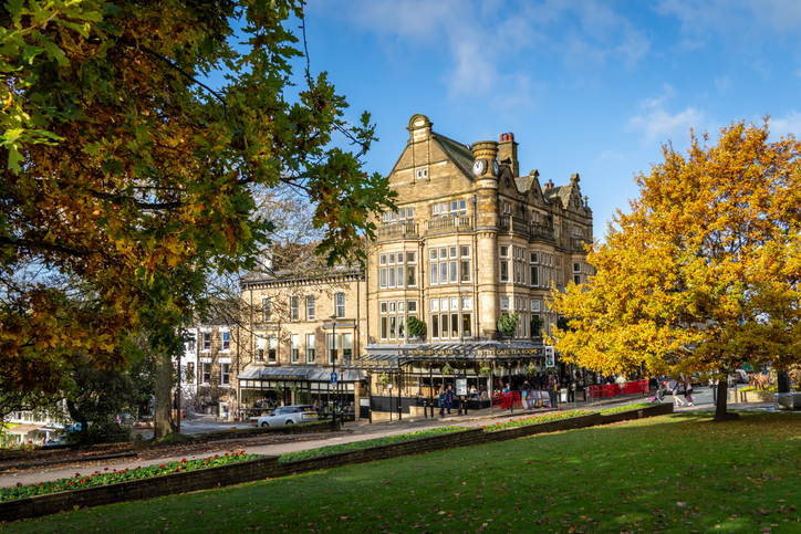 Harrogate , UK - November 7, 2023. The exterior of the Victorian architecture of Betty's Cafe and Tea Rooms in Harrogate, North Yorkshire with colourful Autumn trees