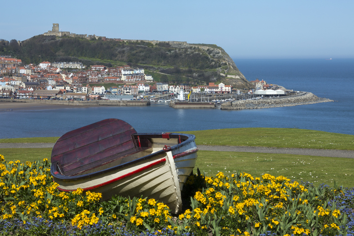 Scarborough Castle on a hillside above the town and harbor - North Yorkshire coast in the northeast of England.