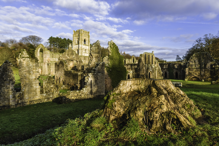 Ripon, Yorkshire, UK. The ruins of Fountains Abbey on a fine autumn morning as viewed from across the river Skell near Ripon, Yorkshire, UK.