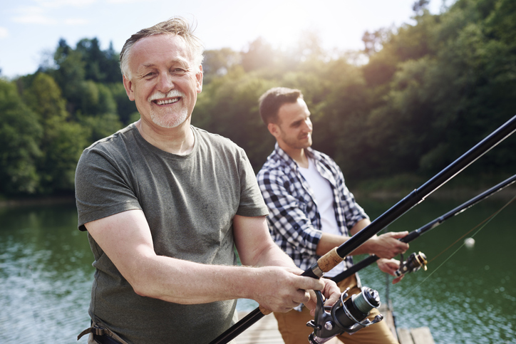 Portrait of cheerful senior man fishing