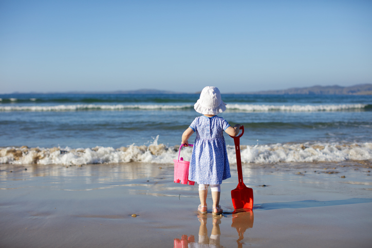 rear view of baby girl playing at the beach