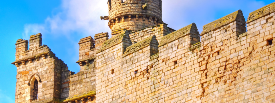 Close-up of the historic Lincolnshire castle wall with a union jack flag flying above.