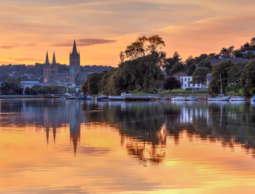 Image across the water at sunset with Truro skyline and cathedral in the background.