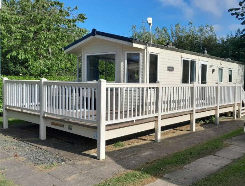 A range of activities are available at Cleethorpes including fishing lakes. External shot of a static caravan in Cleethorpes Beach Holiday Park. The caravan has a wrap around decking and is painted white. The sky behind is bright blue and a single green tree is visible | Cleethorpes Beach Holiday Park - Holiday Accommodation 20122
Cleethorpes, Lincolnshire