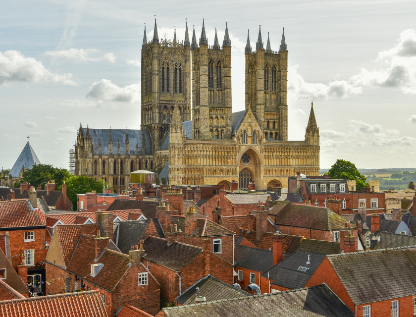 The majestic Lincoln Cathedral towers over the rooftops of the surrounding historic buildings, representing one of the top things to do in Lincolnshire and offering a glimpse into the county's rich architectural heritage and history