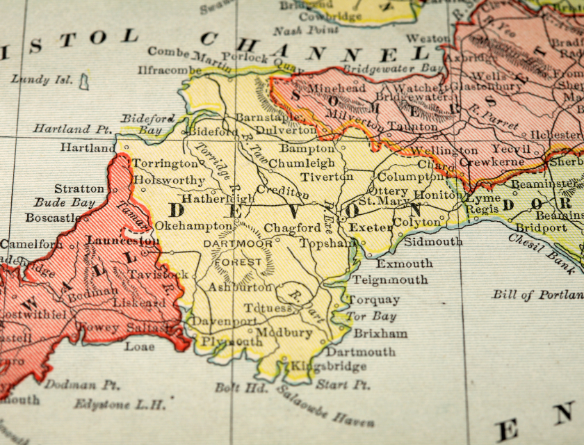 A close-up of an old map of South West England, focusing on the counties of Devon and Cornwall, with towns and landmarks clearly labeled.