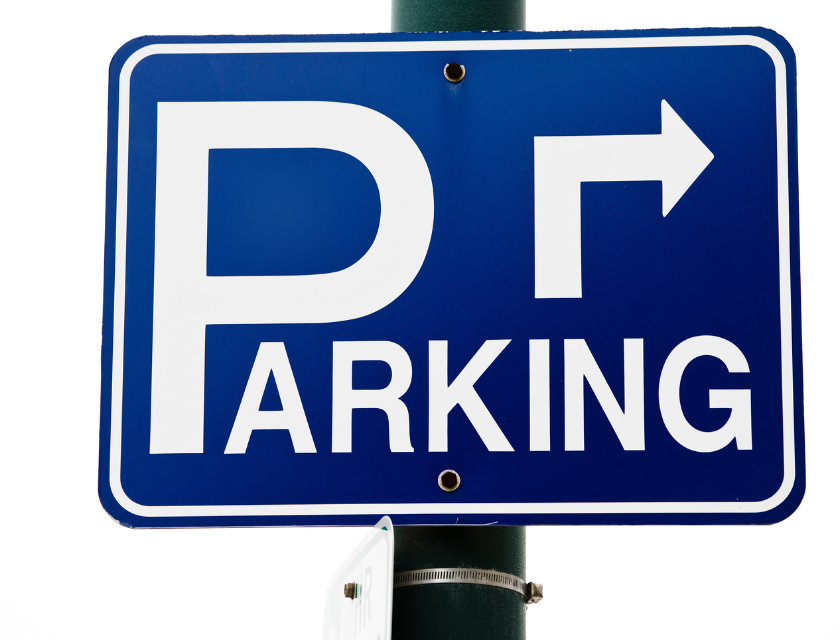 A blue parking sign with a large white 'P' and an arrow pointing to the right, showing the direction of a parking area.