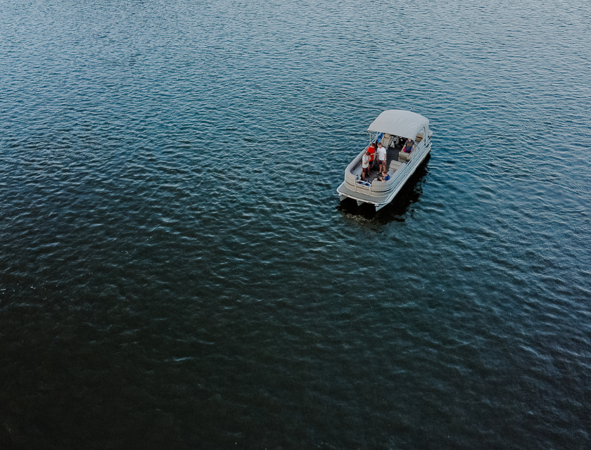 The boating lake is hugely popular with visitors looking for family days out & activities in Cleethorpes. Aerial shot of a lone boat on in a body of water. People are visible on the boat. 