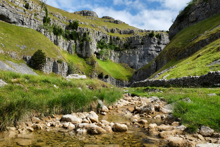 Limestone ravine or gorge, Gordale Scar, with Gordale Beck in the foreground, Yorkshire Dales, UK