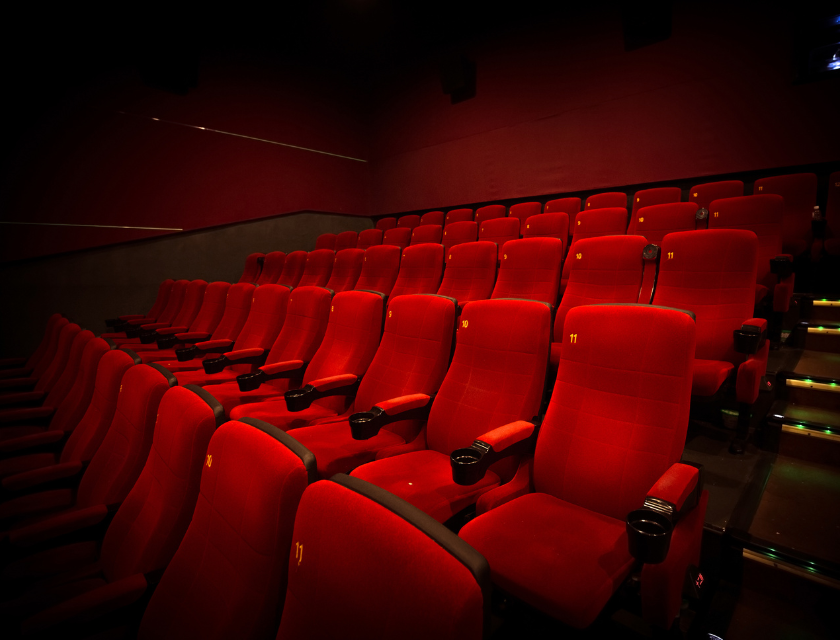 Plush, red seats in a cosy cinema, offering a relaxing retreat after a day exploring Croyde and the surrounding area.