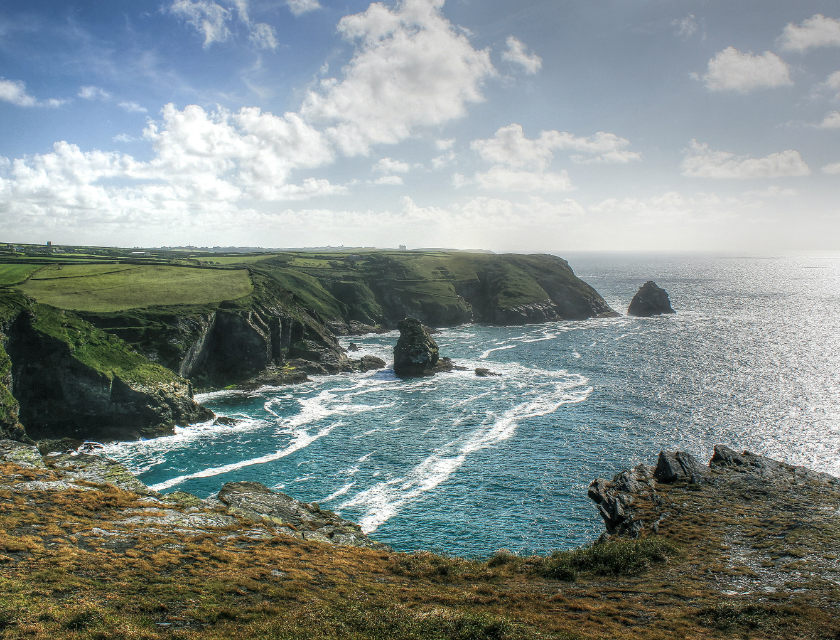 Dramatic coastal cliffs with waves crashing along the shore near Boscastle, offering stunning views for those enjoying the coastal walks in Boscastle.