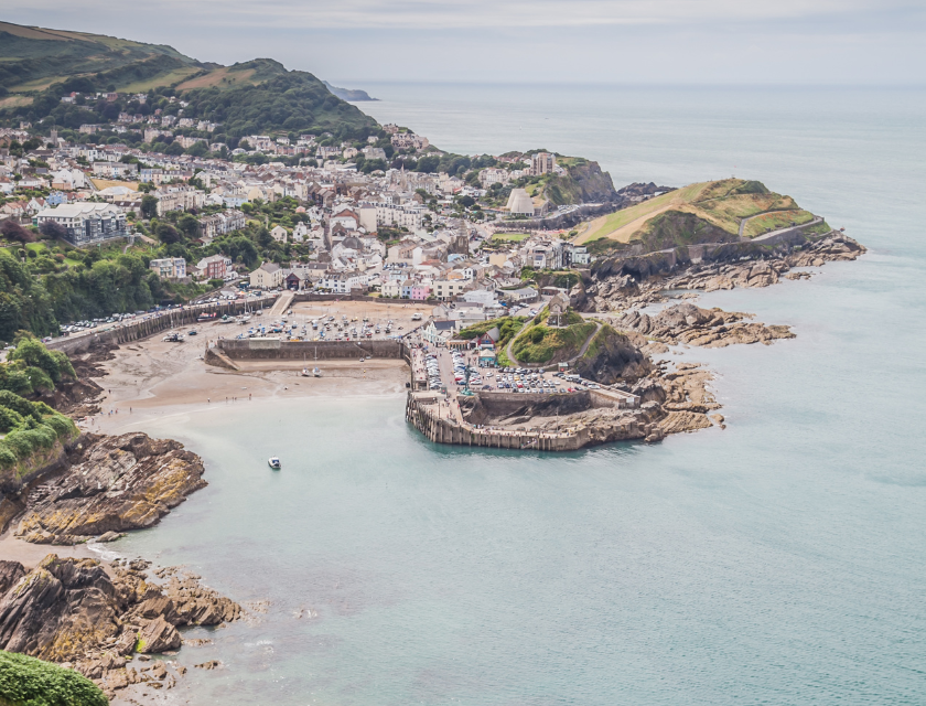 A coastal view of a North Devon town surrounded by hills and the sea – a perfect addition to the list of places to visit in North Devon for stunning vistas.