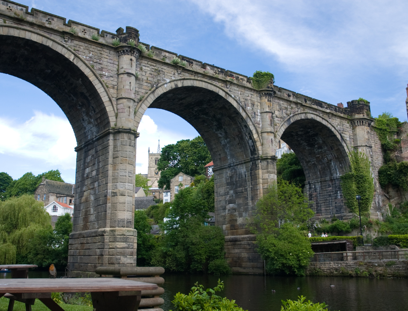 Knaresborough viaduct over the river with scenic greenery, perfect for a festive day out to find the best Christmas markets in Yorkshire.