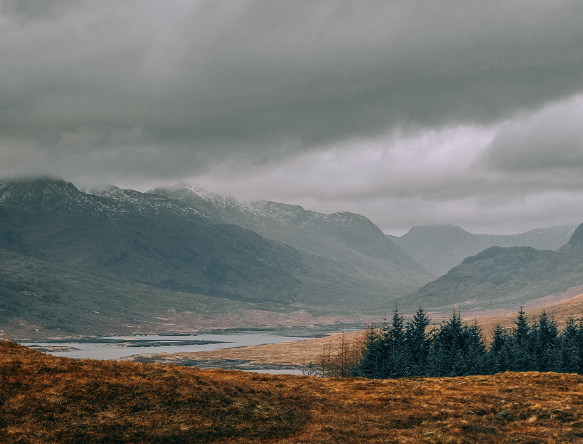 Misty mountain valley in Scotland during winter. A serene and peaceful backdrop for a Christmas caravan holiday in the Scottish Highlands.