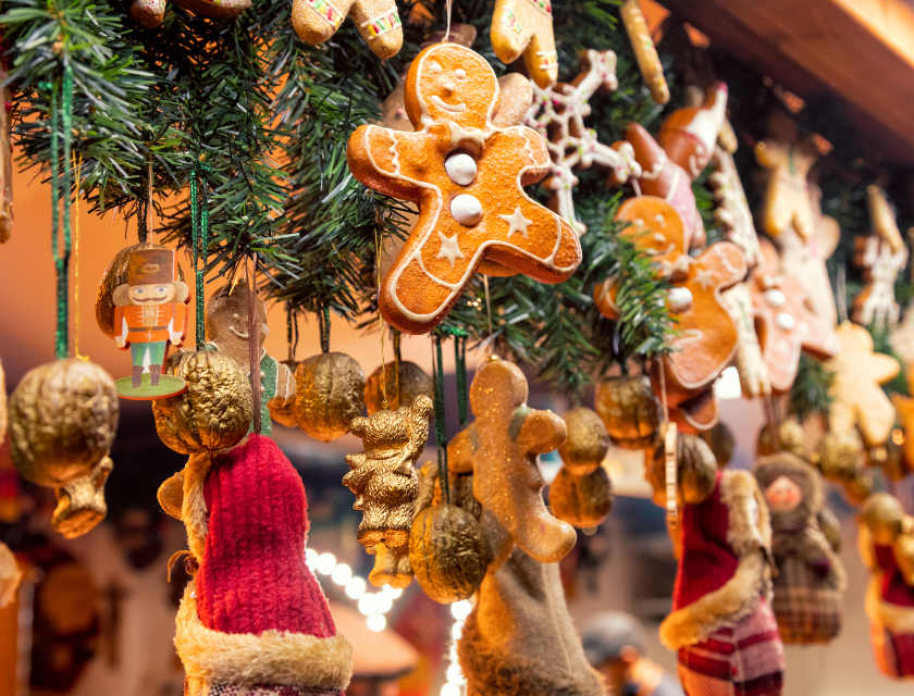 Gingerbread man ornaments and Christmas decorations at a festive market.