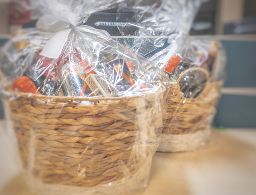 Two gift baskets wrapped in clear plastic, filled with festive treats. Homemade gifts are available at Christmas markets in Lincolnshire.