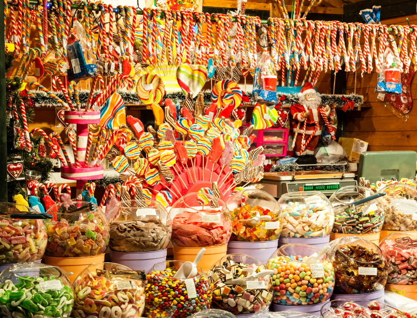 A candy stall at a Christmas market, filled with colourful sweets and lollipops.